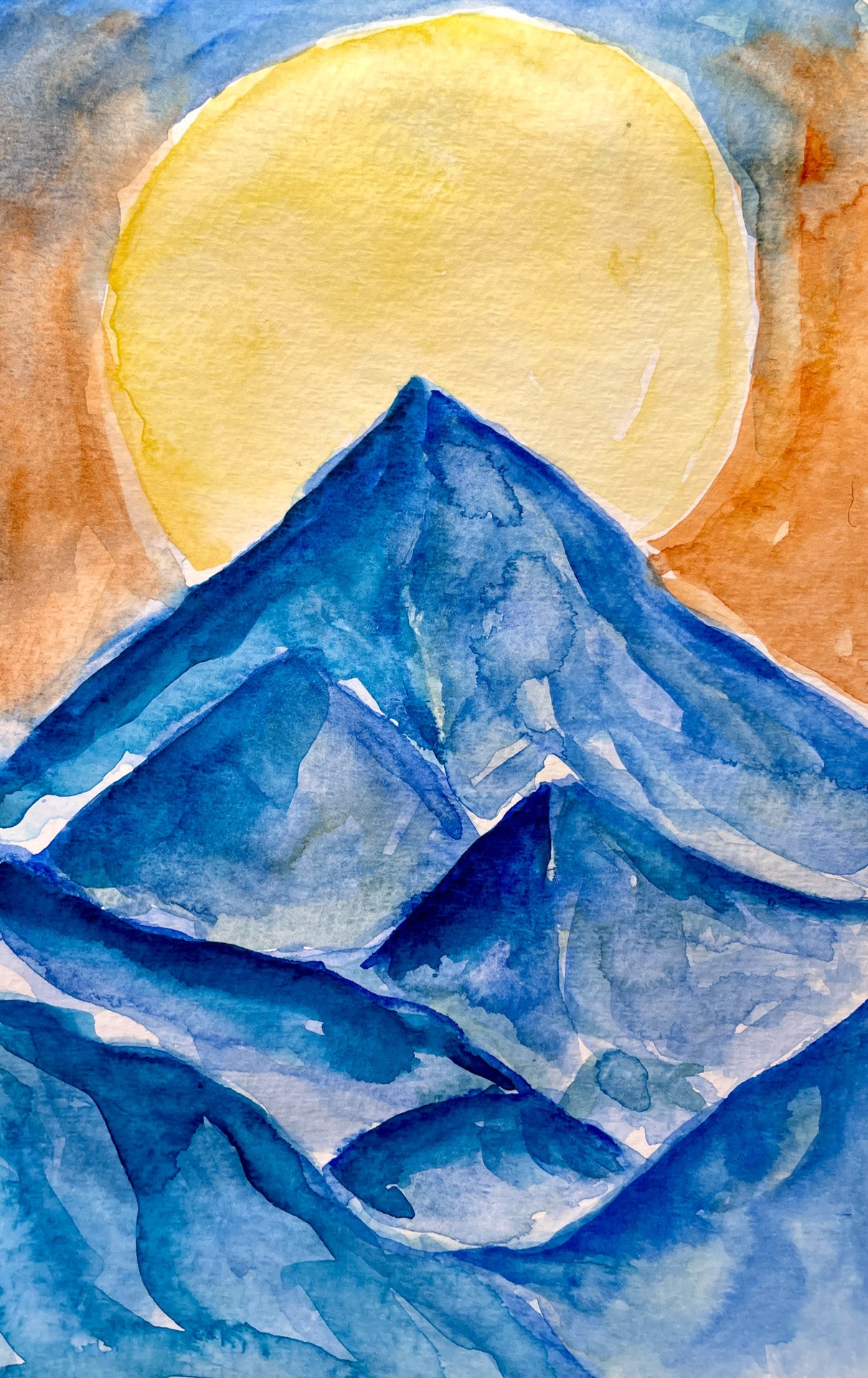 Watercolor painting of blue mountain peaks with a large yellow sun in the background.
